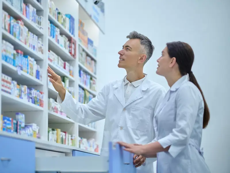 Inventory. Two druggists in lab coats in the process of inventory in a drugstore